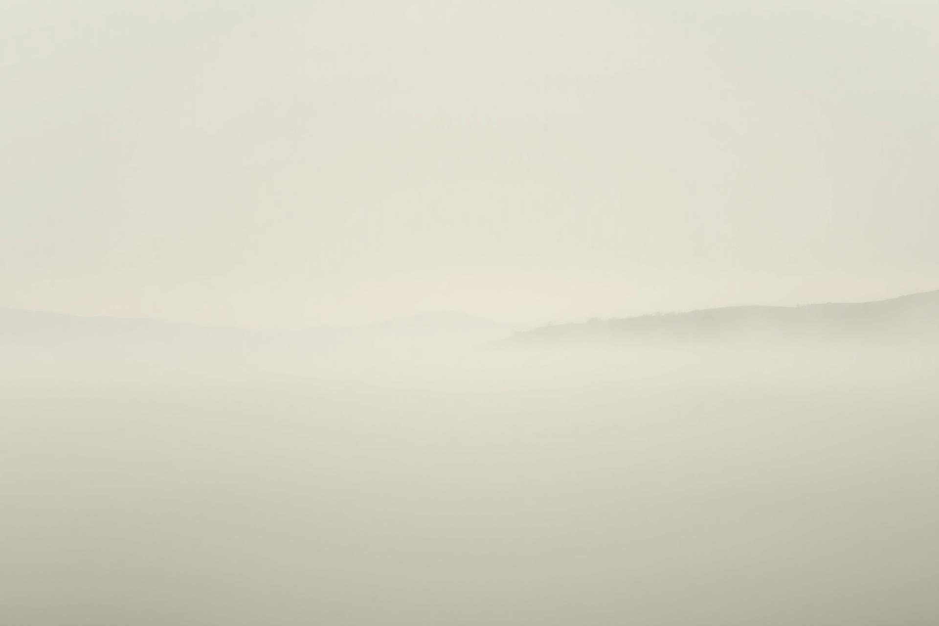 Soft mist over still water at dawn